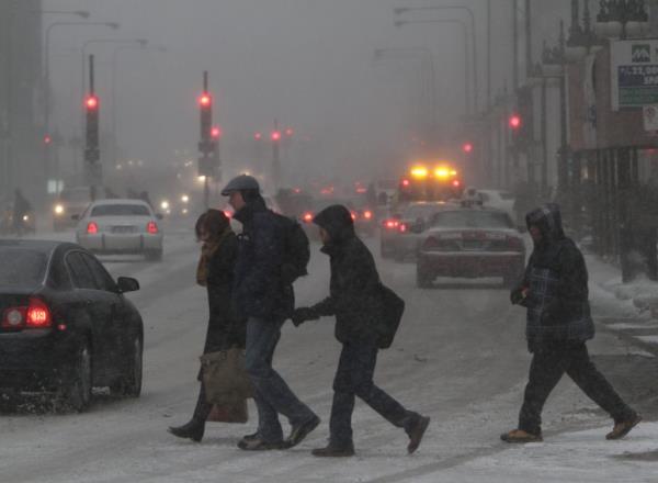 Commuters braving a heavy snowstorm on Michigan Avenue in Chicago on February 1, 2011