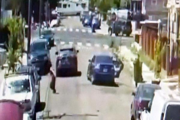  is seen running to the other side of the street as the gunman turns to shoot Ramos' mother who fled the shooting.