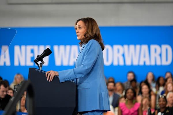 Democratic presidential nominee Vice President Kamala Harris standing at a podium with a microphone at a campaign event at Hendrick Center in 2024