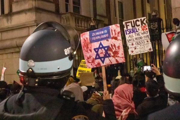NYPD officers surround protesters near Columbia University Saturday evening.