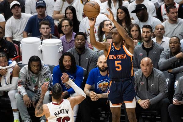 mmanuel Quickley #5 of the New York Knicks puts up a three point shot over Caleb Martin #16 of the Miami Heat
