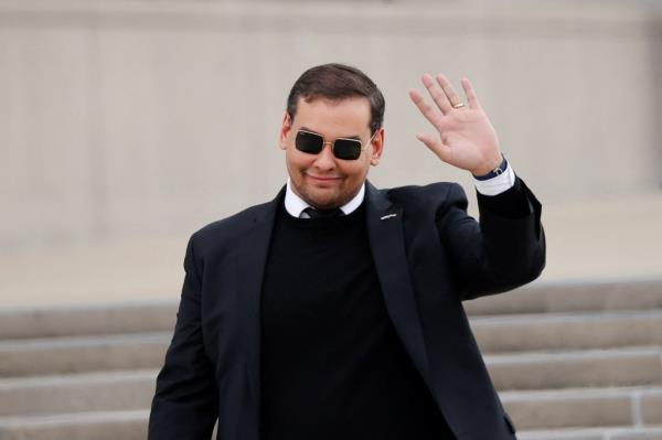 U.S. Representative George Santos (R-NY) gestures, as he walks outside the Central Islip Federal Courthouse on the day of his hearing.