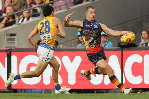 Tom Cole of the Eagles tries to tackle Taylor Walker.