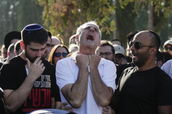 Yigal Sarusi, centre, mourns during the funeral of his son, slain hostage Almog Sarusi, who was killed in Hamas captivity in the Gaza Strip, at a cemetery in Ra’anana, Israel.