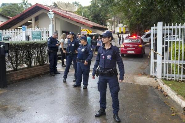 Police guard the gated community wher<em></em>e a plane crashed in Vinhedo, Sao Paulo state, Brazil.