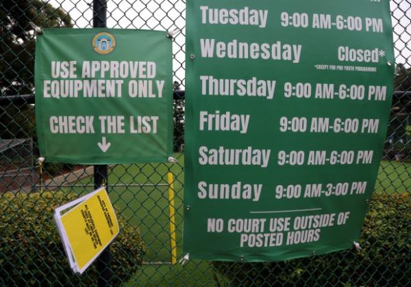 Signs and a booklet listing approved pickle ball equipment on...