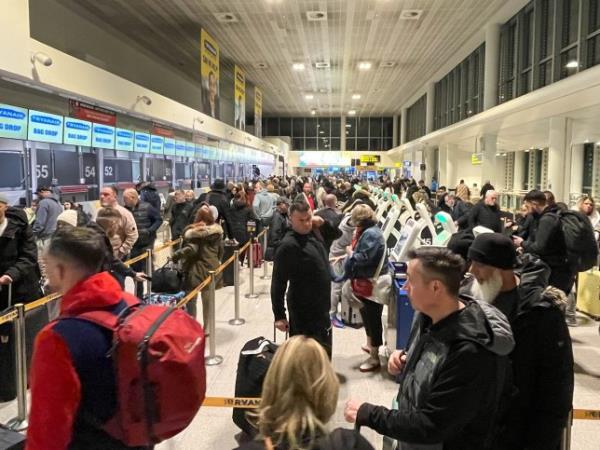 Holidaymakers queue for check-in at Manchester Airport terminal 3 this morning. Large queues are forming at airports, railway stations, ports and roads as members of the public get away for the Christmas holidays.