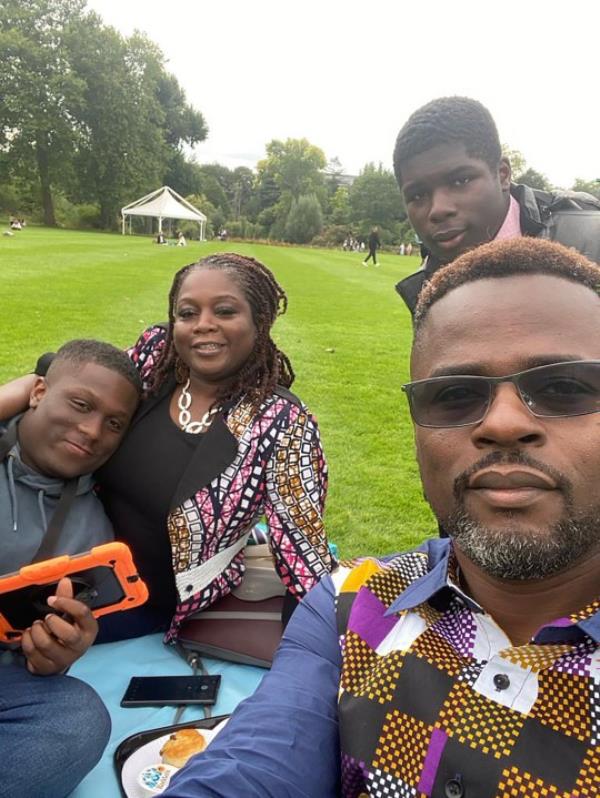 Anthony and Abi with both sons, in a park havin<em></em>g a picnic