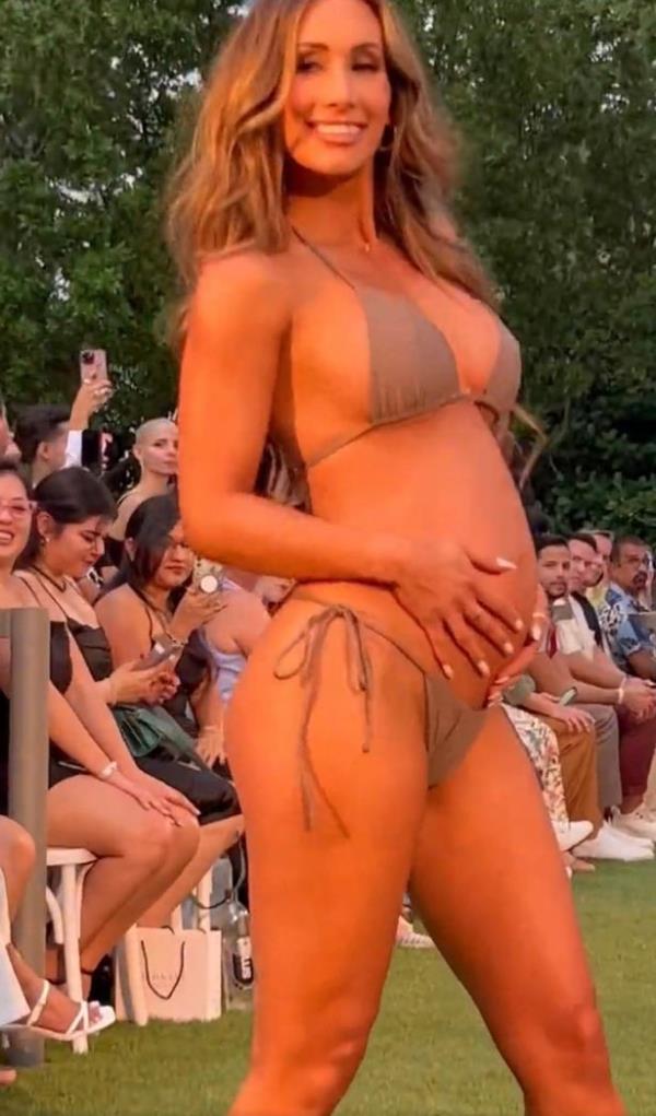 Carmella has taken to the runway to show off her baby bump