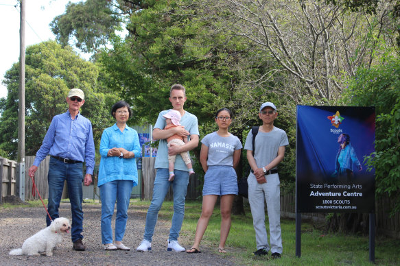 Resident Tim Denning (centre) with his baby and other Blackburn South residents who oppose the performing arts centre. 
